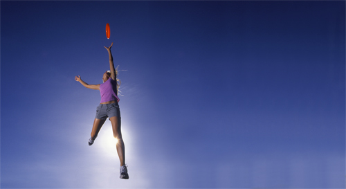 Backlit Woman Stretching for Disc